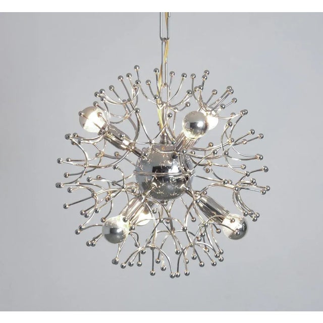 This chrome-plated sputnik chandelier is a nice design of the 1960s. The central chrome-plated sphere and the chrome...