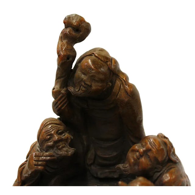 This is a collectible and decorative oriental sculpture depicting 3 old men figure carved from a natural bamboo plant....