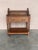 20th century Pair of solid carved Spanish nightstands with turned columns and low shelve. The nightstands have a crest to...