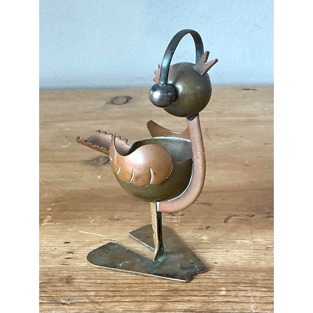 This charming mid-century ashtray is a standout example of the whimsical metalwork synonymous with vintage Mexican design....