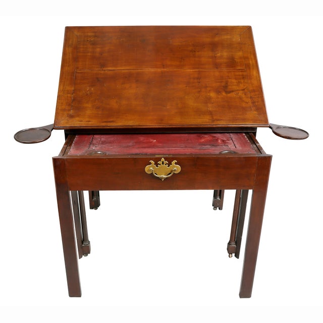 Rectangular hinged top side table with lower pull out drawer, raised on square legs.