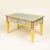 Hand-painted coffee table with a yellow base color adorned with light blue and red dots. Includes a single drawer and...