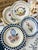 This is a set of four ceramic plates featuring exquisite floral patterns. These plates are a wonderful way to add color...