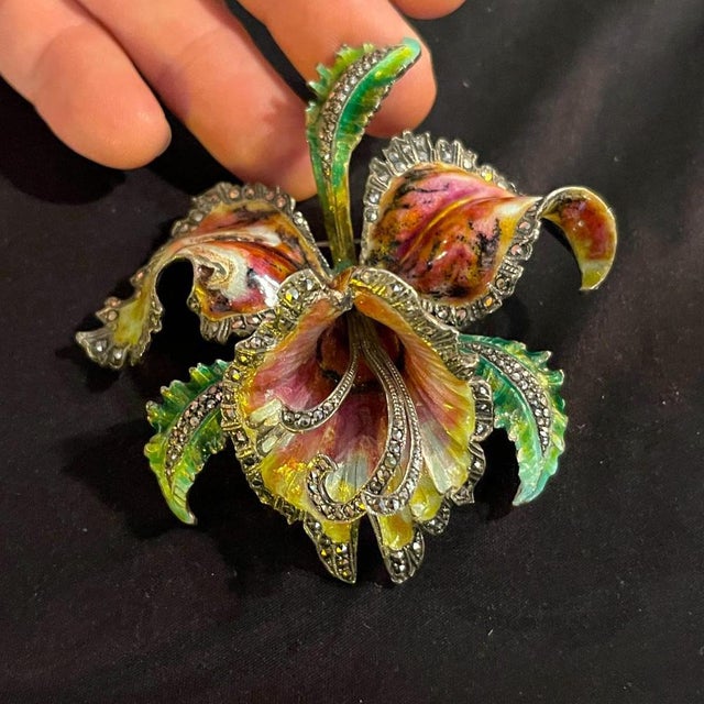 Enamelled silver brooch depicting an orchid or Iris. Although the flower is inspired by the Art Nouveau style, this is a...