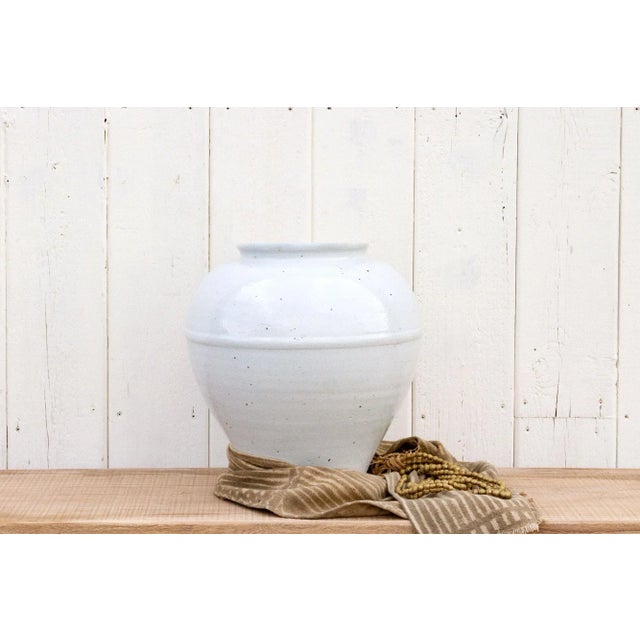 This tall off-white glazed Jar is an impressive container for flowers since the interior is glazed as well and it can hold...