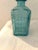 Colorful pair of vintage clear glass decanters in blue and Canary yellow in geometric designs. Each with plastic twist off...