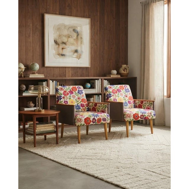 A stunning and cheerful matching pair of fully refurbished vintage retro lounge armchairs, featuring rich wooden frames...