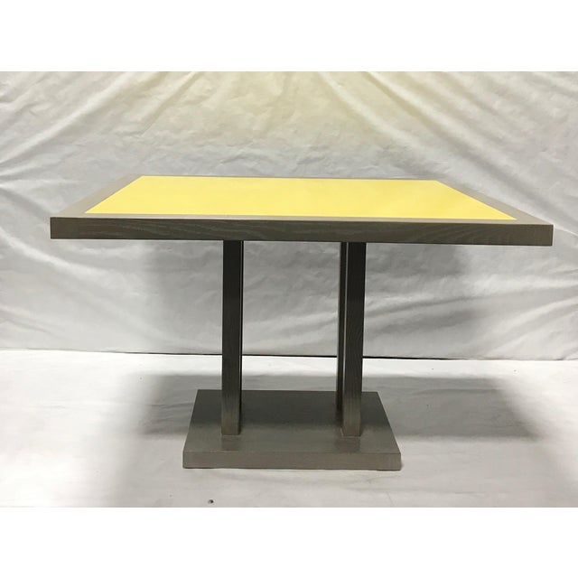 Pair of cerused oak dining tables with yellow laquered top. The wood frame is stained Miniwax Classic Gray, while the top...