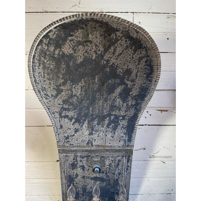 Lot #230 A pair of tin three lamp electrified sconces in a deco style with a curvaceous back plate outlined by a hammered...