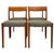 This set of four mid century modern dining chairs features clean, sculptural lines and a warm-toned wood frame. Each chair...