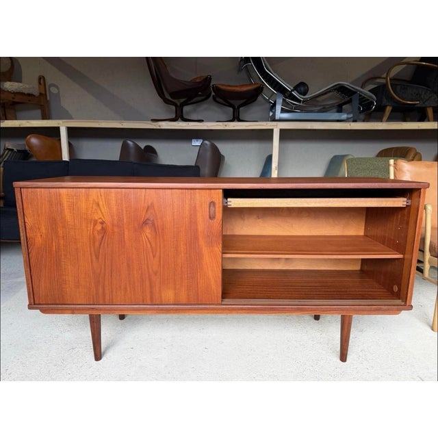 In good used condition with minor age related signs of use. This stunning Mid Century Danish Modern Teak Credenza...