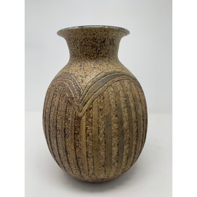 beautiful, mid- century hand made ceramic vase with intricate carvings