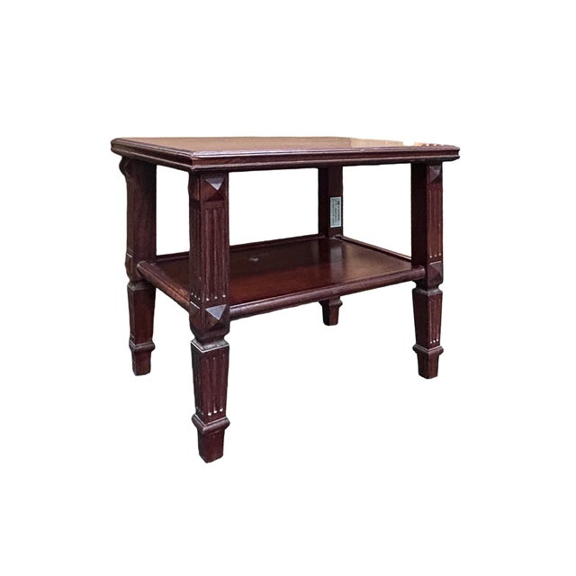 This handsome side table is crafted from a rich, dark-grained hardwood—likely rosewood or mahogany—boasting a deep...