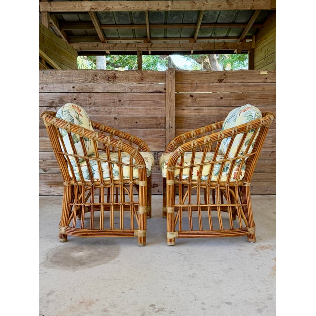 A charming pair of vintage Henry Link pencil rattan lounge chairs featuring the iconic sculptural frame and original...
