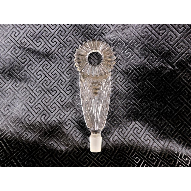 This is a small, square, cut glass perfume bottle and what I think is a mismatched, but very nice, tall flower shaped...