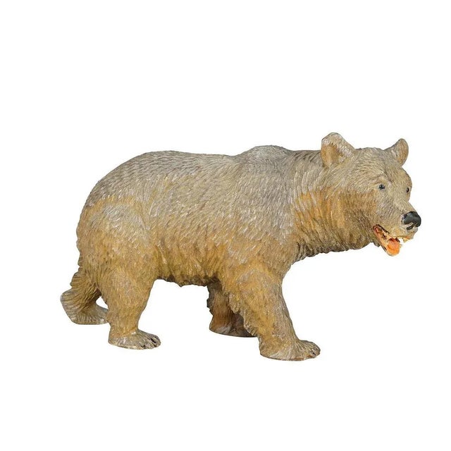A vintage statue of a black forest walking bear. Made of lindenwood, finely handcarved with naturalistic details in...