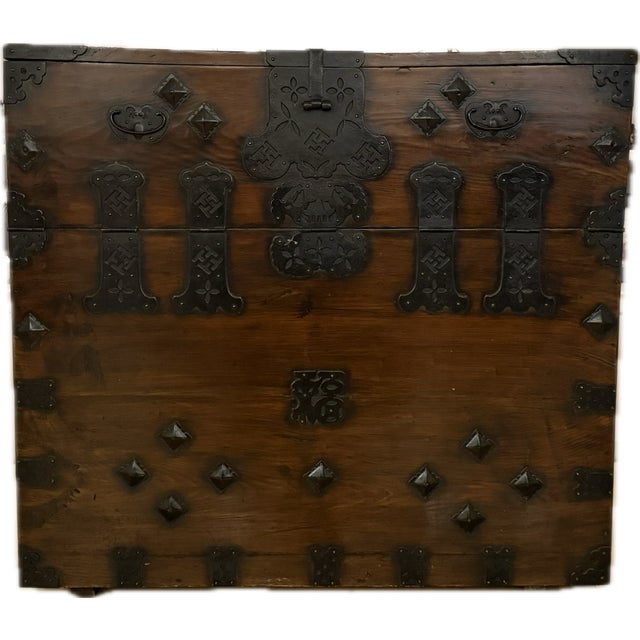 This piece is a large Antique Korean Bandaji storage chest, made of warm-toned hardwood with extensive black iron...