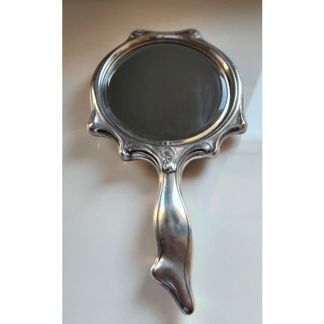 This beautiful decorative hand mirror is made of silver plating and a very clear clean mirror. It's a great useable...