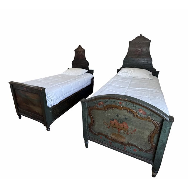 A rare and beautifully timeworn pair of 19th century hand-painted twin beds, dating to the circa 1800s. Rich in character...