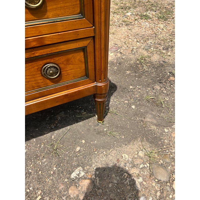 Elegant 19th-century Louis XVI style commode featuring a beautifully figured wood veneer with classic neoclassical lines....