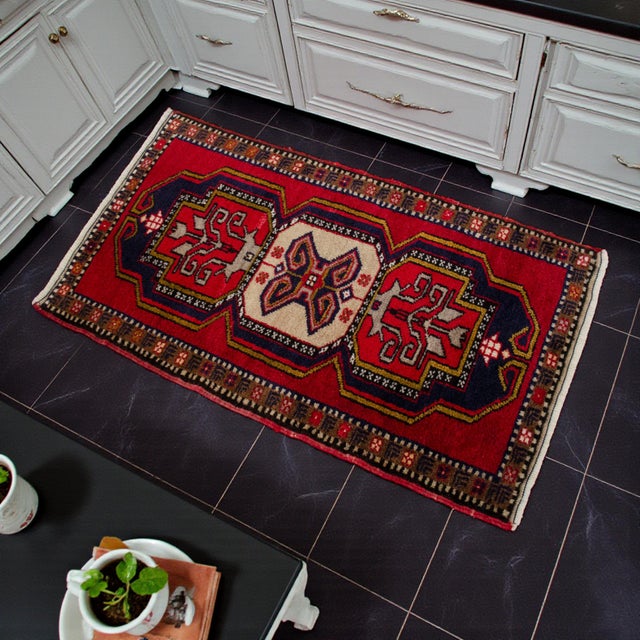 Welcome to our curated collection of authentic Anatolian textiles. This stunning vintage small rug brings an immediate...