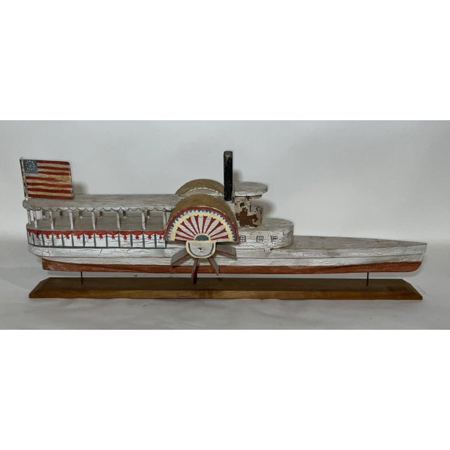 Primitive paddle wheel steamboat with painted paddle box covers, twin steam funnels, flag, wheelhouse, etc. 14" H x 37" W...