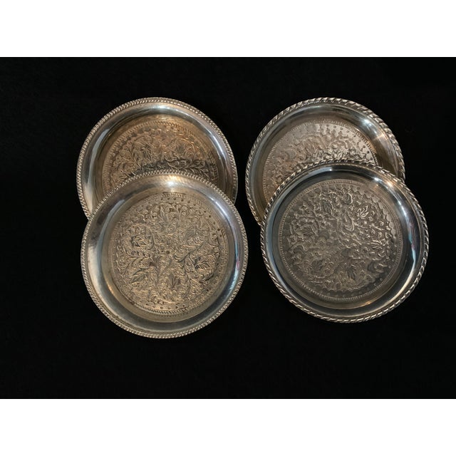 A beautiful vintage set of four (4) matching drinking coasters. These highly decorative pieces feature an intricately...