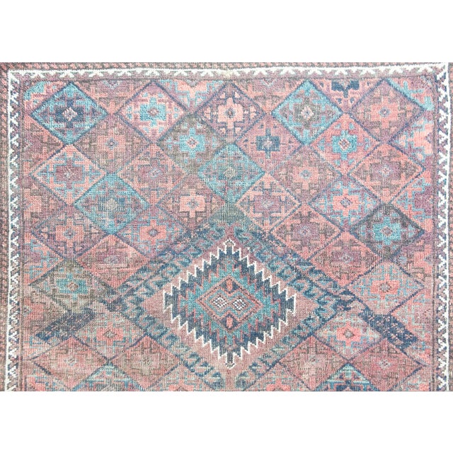 A chic and quiet early 20th century Persian Baluch rug with a central diamond medallion surrounded by a geometric pattern...