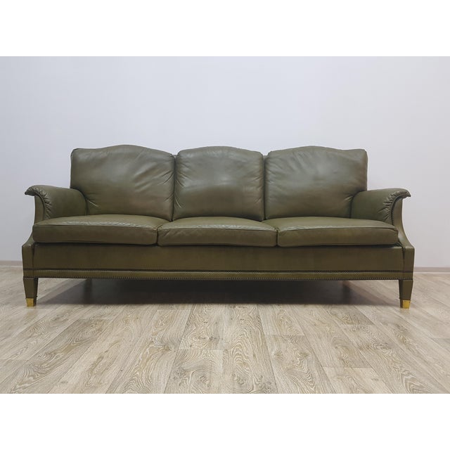 An elegant leather Chesterfield sofa, produced in the 1960s and 1970s. Covered with natural green leather. The sofa is...