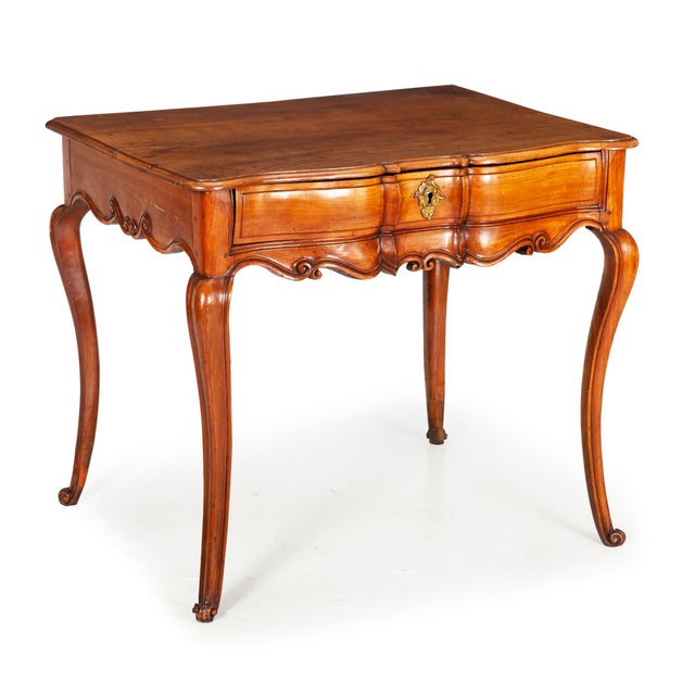 LOUIS XV CHERRYWOOD WRITING TABLE Southern France, circa mid-18th century 28" H x 24 3/4" D x 33" W A table that looks...