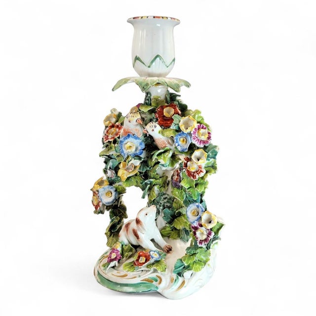 Rare 18th-century Derby porcelain candlestick, modelled with two finches nestled within a dense floral bocage above a...