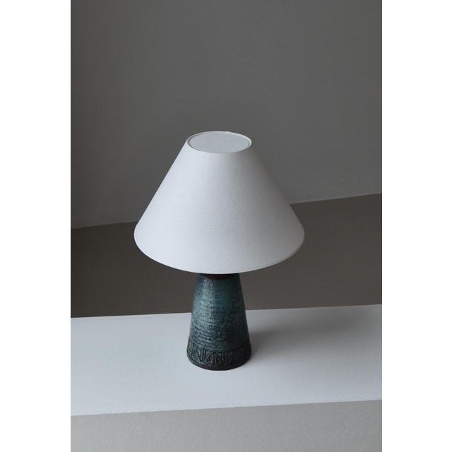 Sculptural and richly textured, this unique Scandinavian Modern 1960s table lamp by Sejer exemplifies the refined...