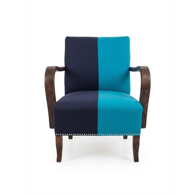 A striking and bold matching pair of fully refurbished vintage "Rumba" lounge armchairs, celebrated icons of mid-century...