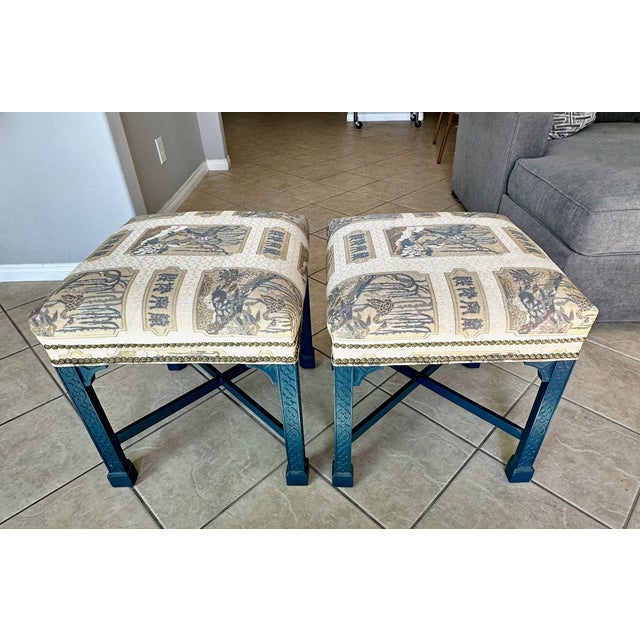 Pair of mid-to-late 20th-century footstools/benches crafted in the elegant Chinese Chippendale tradition. The solid wooden...