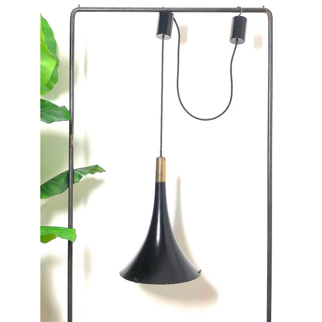 Vintage 1960s Chandelier Made in Italy. The chandelier is made of enameled metal with gold-plated brass details, with an...