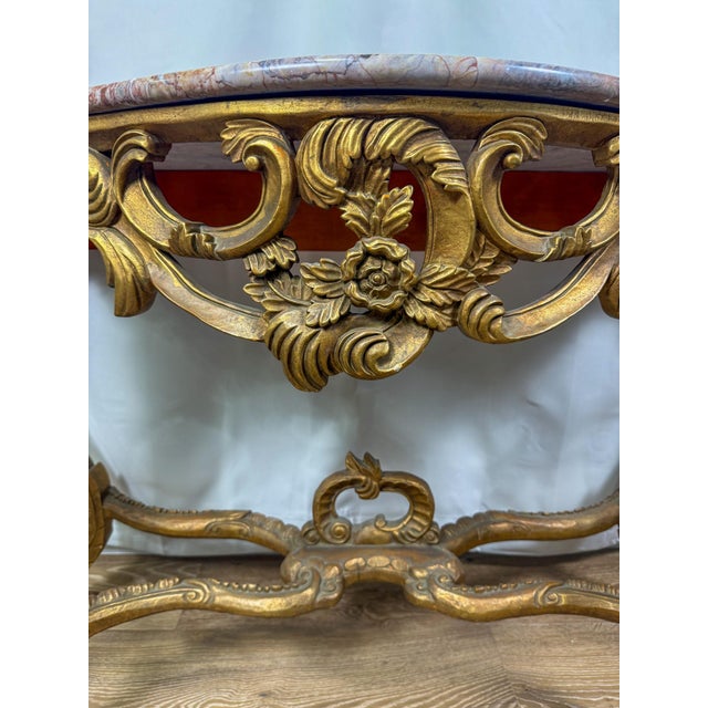 Console tables are characterized by their narrow depth and often ornate designs. This table's elaborate carvings and...