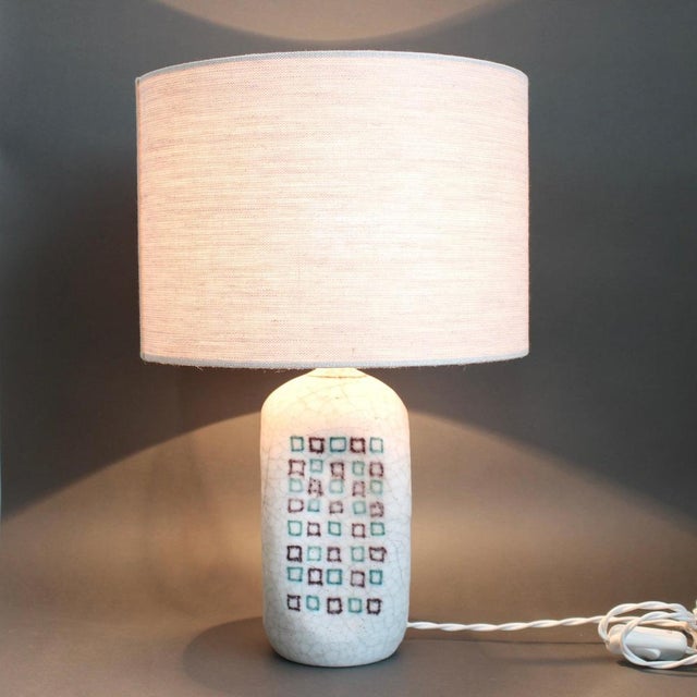 Decorative italian ceramic table lamp by guido gambone (circa 1950s). The piece is hand painted in a soft, milky white...