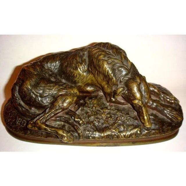 French bronze sculpture of a resting dog. Exceptional old patina. Signed "Rochard".
