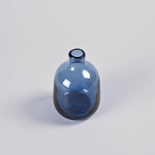 Cylindrical vase with a narrow neck by Claude Morin, made of mouth-blown glass, slightly bubbly and tinted blue...
