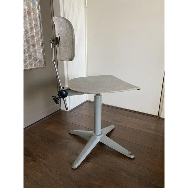 Vintage Modernist Desk Chair. Designed and manufactured in the 1950s. The chair has the original upholstery. This piece is...