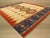 A handwoven wool flatweave, made in India and measuring 5' x 8'. Geometric drawing - repeating motifs held inside strong...