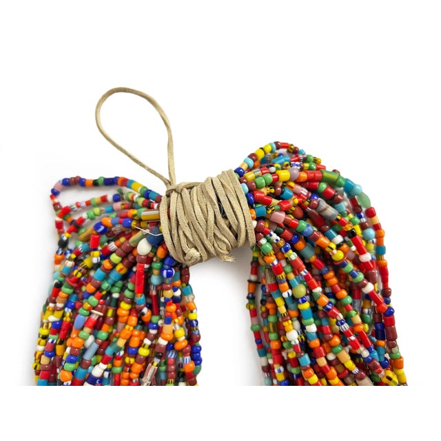 Vintage handmade colorful beads strung together on leather strands to create a stunning vibrant bundle. Wonderful...