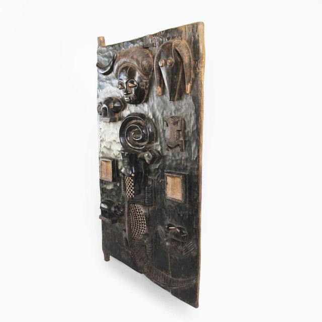Original vintage Baule grain door panel. Traditional fine carved symbolic images of a portrait, ram, snake, chameleon,...
