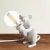 A cheeky cast resin lamp depicting a field mouse holding a light bulb. Is he trying to help out, or is he stealing your...