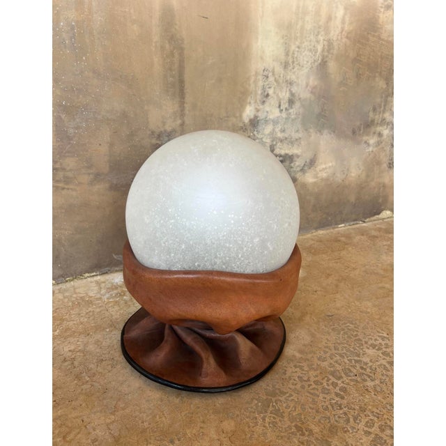 A striking and uncommon Nova Tecno table lamp, crafted in Italy during the 1970s. This sculptural piece masterfully...