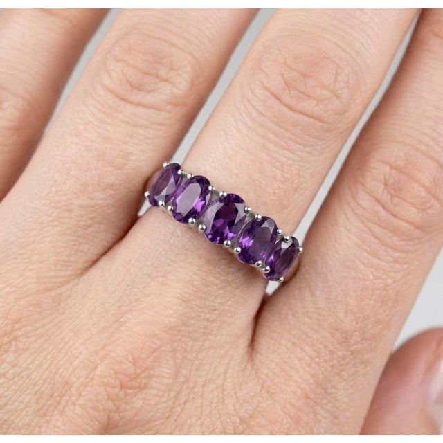 Elegant and timeless, this refined ring features a stunning row of Amethyst gemstones, designed to add a touch of regal...