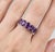 Elegant and timeless, this refined ring features a stunning row of Amethyst gemstones, designed to add a touch of regal...
