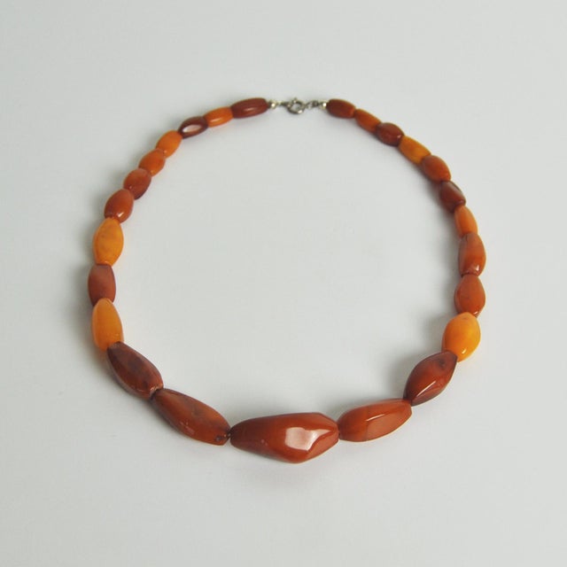 Danish Art Deco honey amber bead necklace with a silver ring bolt clasp. The beautiful amber beads are graduated from 1.1...