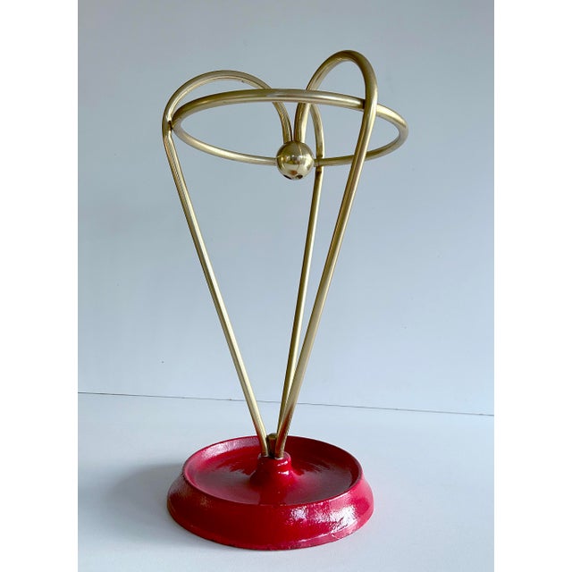 Midcentury umbrella stand, 1950s s made of golden color anodized aluminum arches (making a heart shaped pattern) joined in...