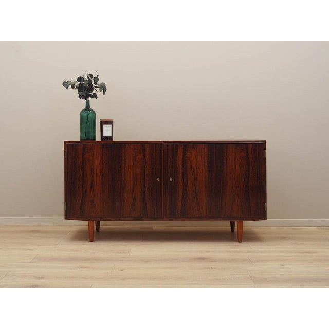 The cabinet was made in the 1970s by the Danish manufacturer Hundevad & Co. It was designed by the renowned designer Carlo...